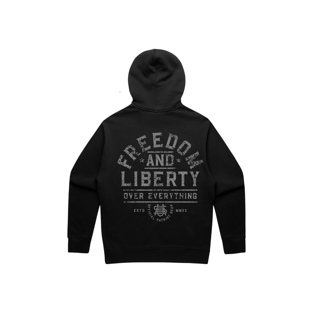 Back view of a black hoodie with grey distressed letters. The whole wording is "Freedom and Liberty over Everything" The word freedom is arched across the back. and the other words are nested underneath FREEDOM. The bottom has a USA logo and "official patriot gear" as well as the roman numerals for 2020 (when OPG was founded).