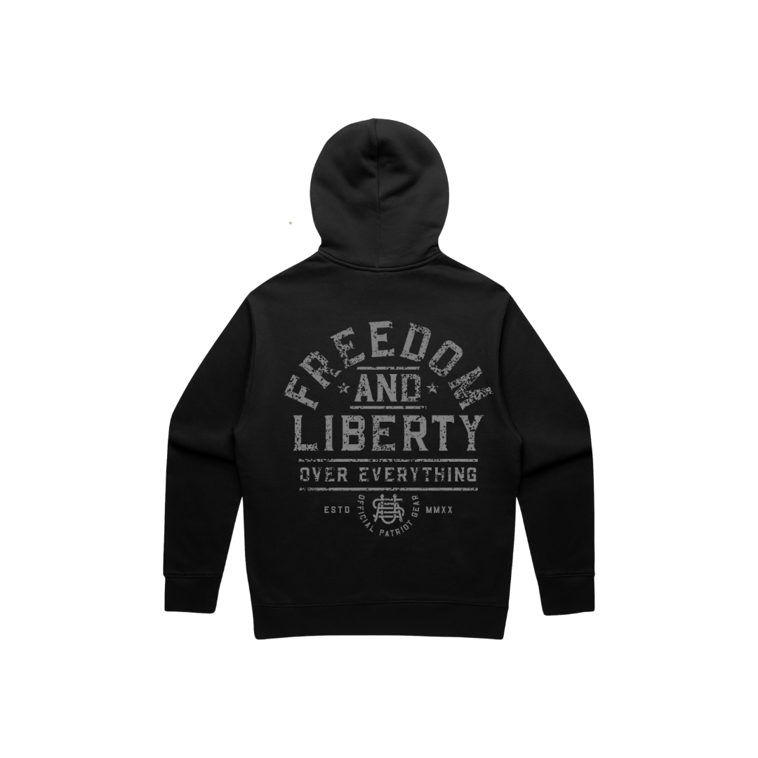 Back view of a black hoodie with grey distressed letters. The whole wording is "Freedom and Liberty over Everything" The word freedom is arched across the back. and the other words are nested underneath FREEDOM. The bottom has a USA logo and "official patriot gear" as well as the roman numerals for 2020 (when OPG was founded). 